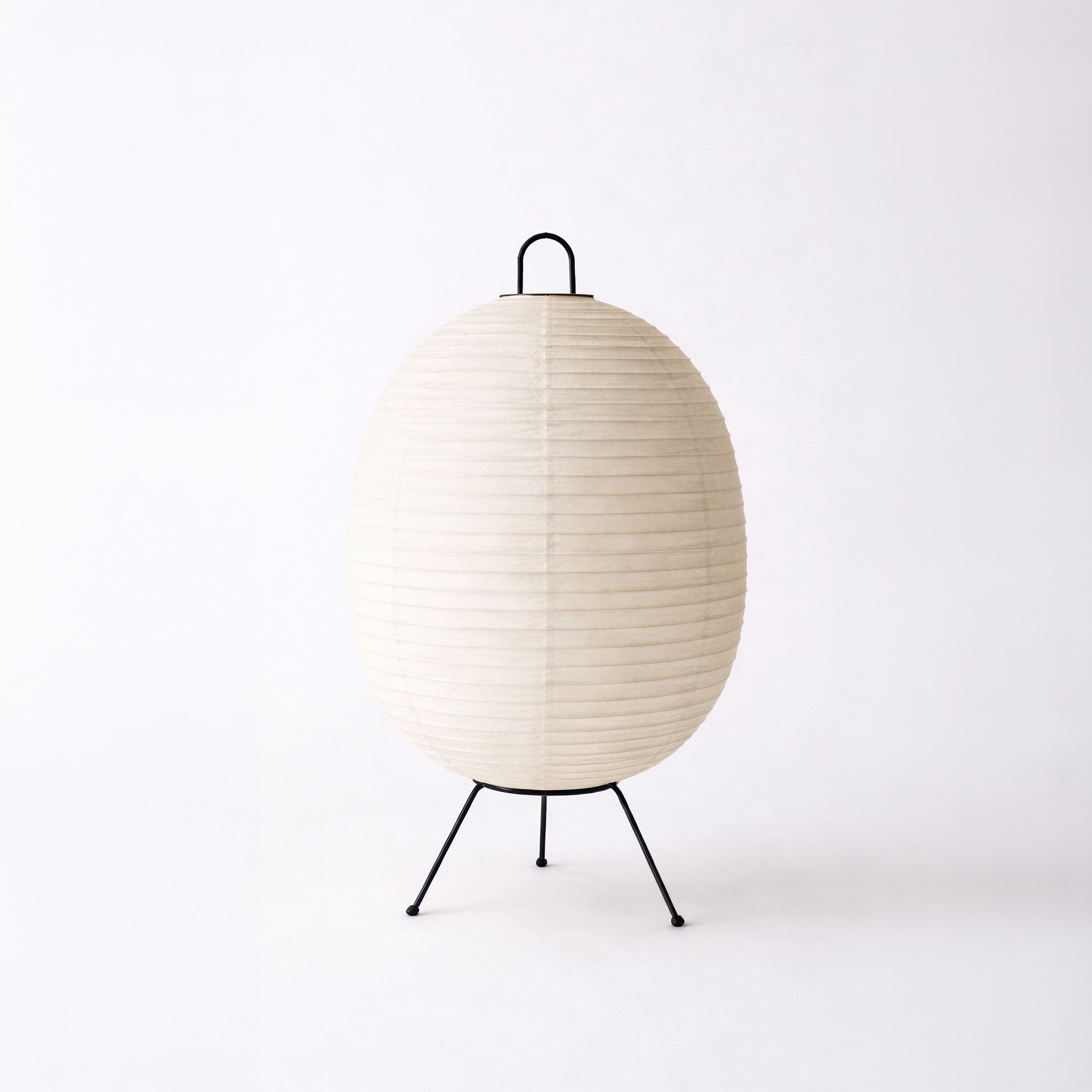 Round paper Asano Tawara lamp with black stand on a light  background