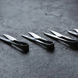 Set of Terazaki Hamono Tsume Scissors on a dark textured surface