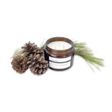 image of an open jar of terralite scented candles nordic pine scent next to pine cones