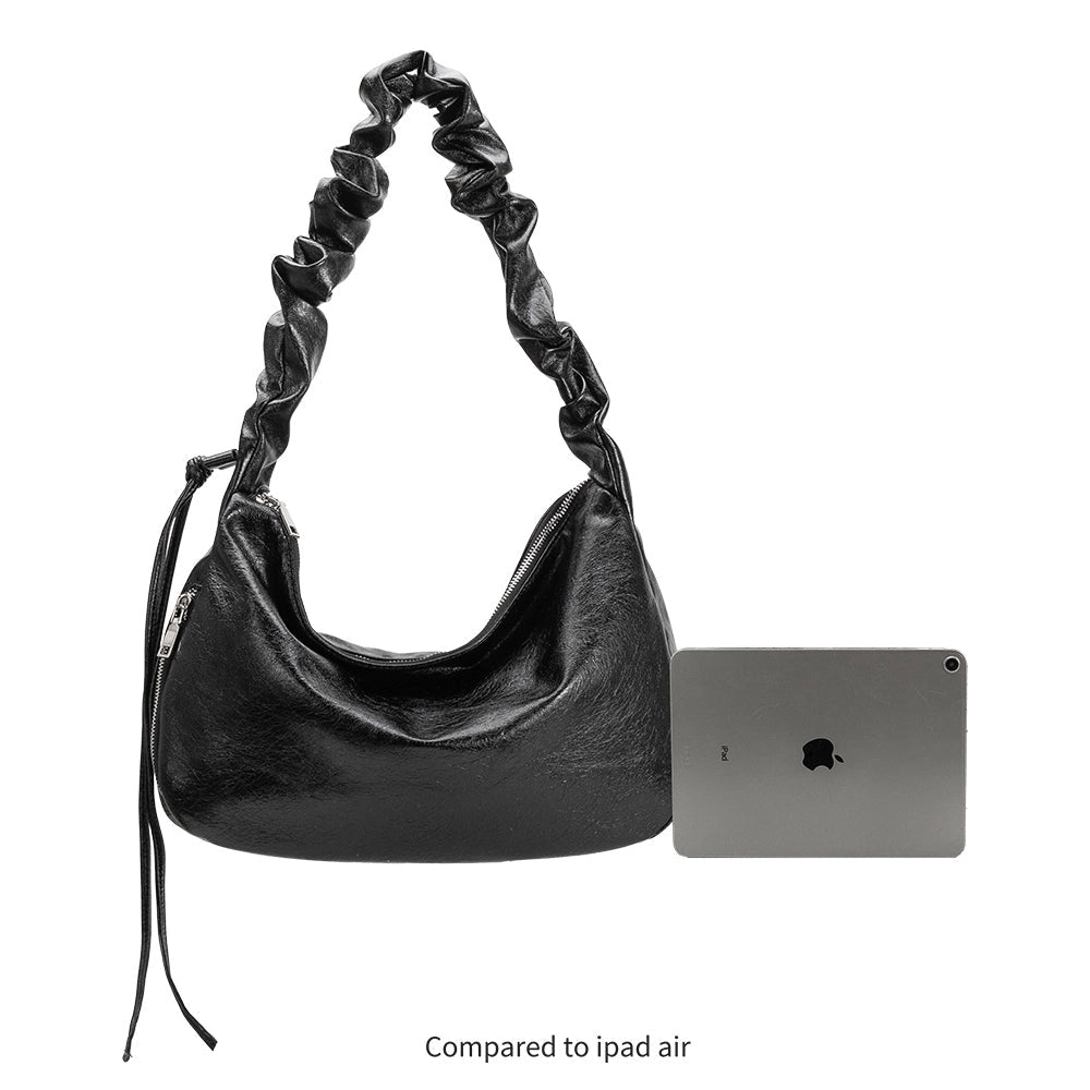 Side by side image of the Reign Shoulder Bag in black comparing the size to an ipad air