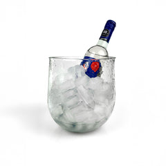 Glass ice bucket filled with ice and a vodka bottle, showcasing hammered texture and wide open top.