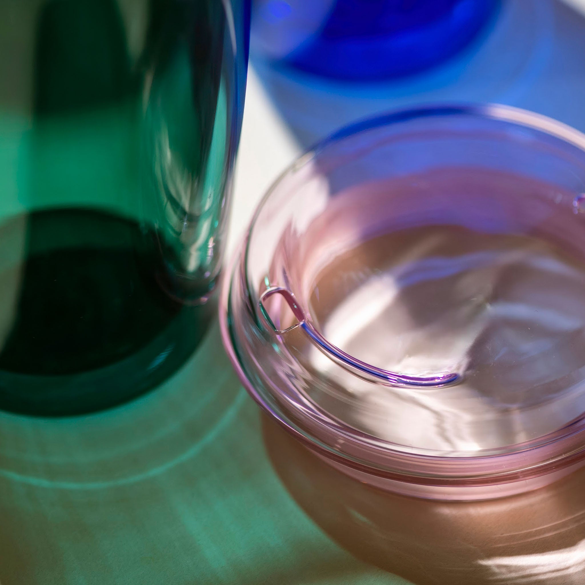 Close-up of a cuddle cup  lid and the newly designed spout on a reflective surface