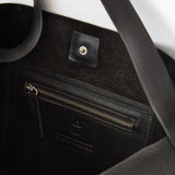 close up image of bonarda bag color black interior showing zipper pouch 