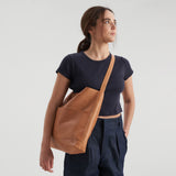 image of bonarda bag color saddle  hanging on woman's shoulder