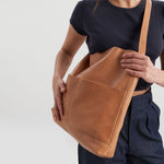 image of bonarda bag color saddle  hanging on woman's shoulder