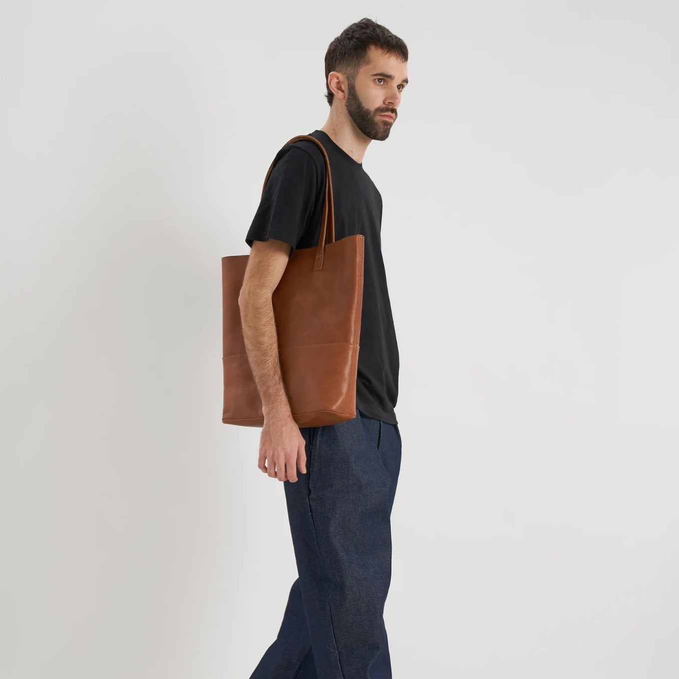 Full length view of model carrying the Cabildo Tote by Nimes in tobacco on his shoulder