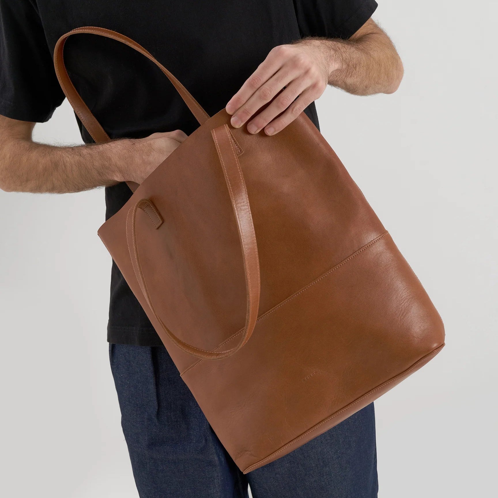 A model looking inside the Cabildo Tote by Nimes in tobacco