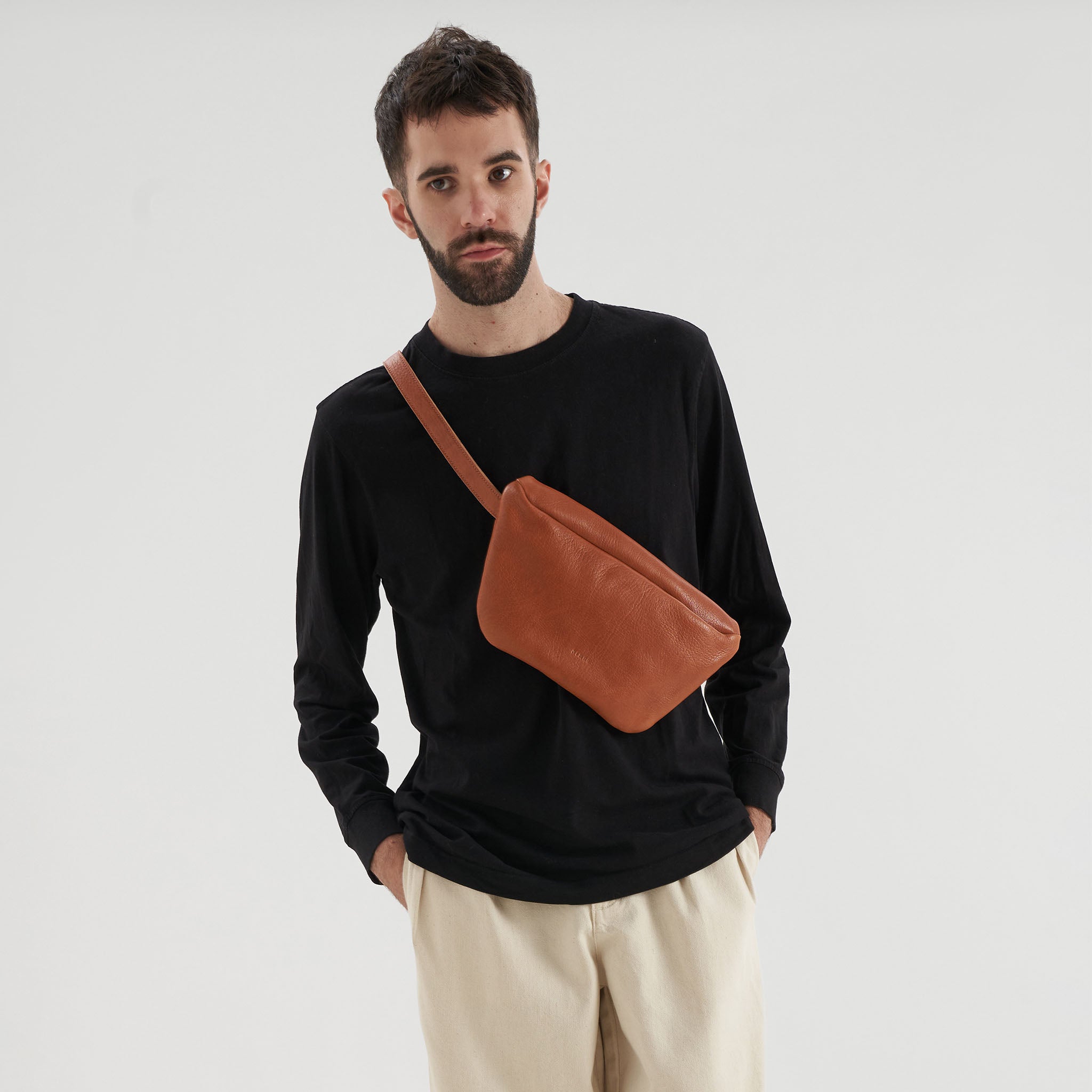 image of modelswearing nimes conesa fanny packs tobacco color over chest