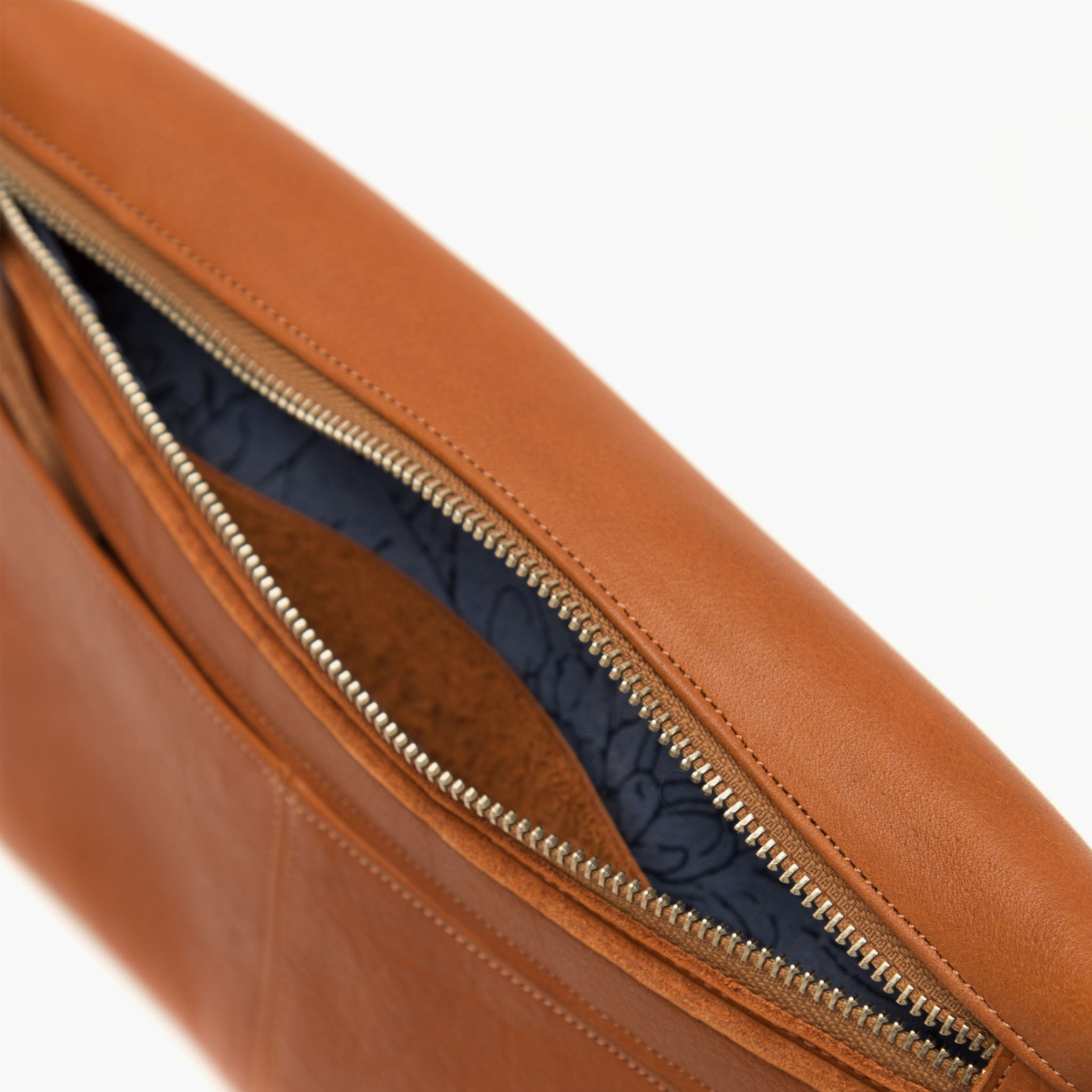 close up image of nimes conesa fanny pack tobacco color showing zipper open