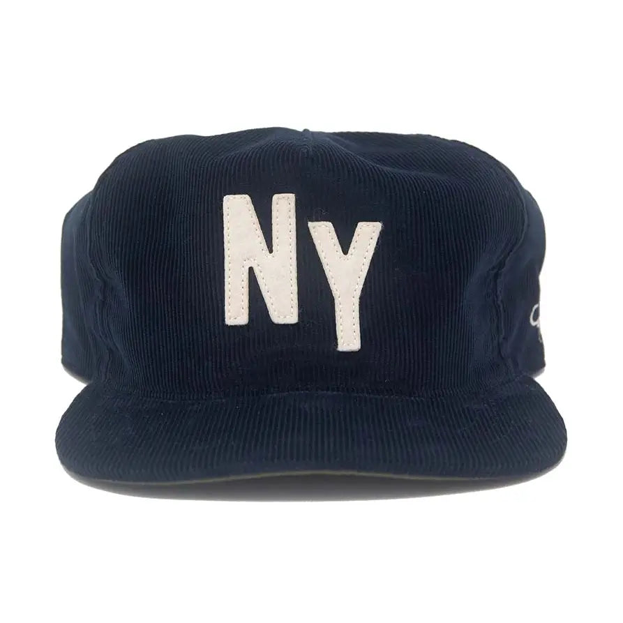 A dark navy blue corduroy cap with 'NY' embroidered in white on the front, shown against a plain white background.
