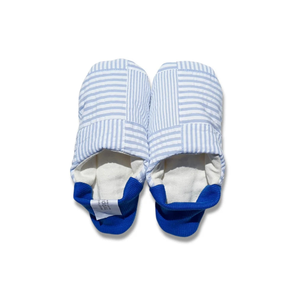 Pair of blue and white striped slippers with blue heels on a white background