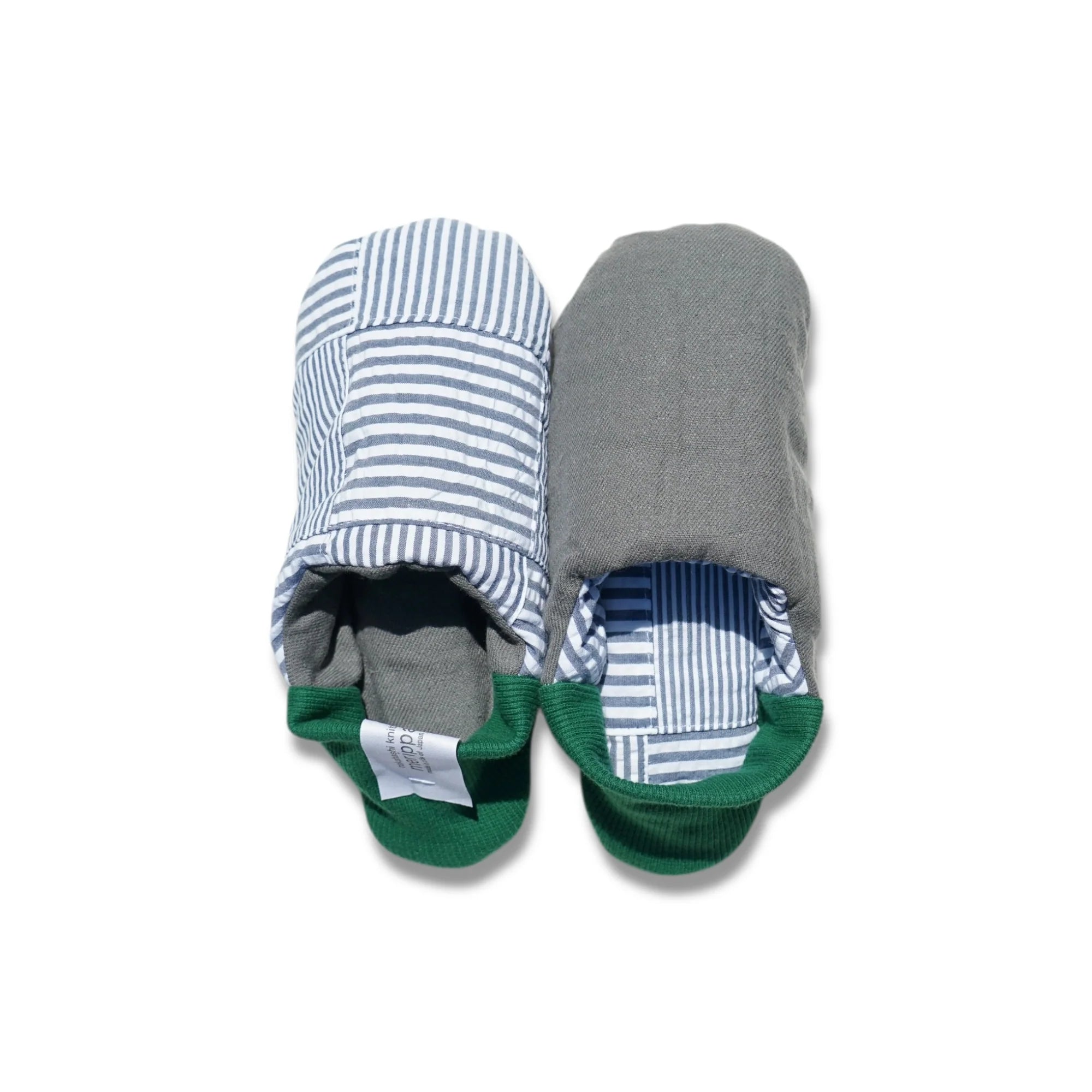 Pair of blue striped slippers with green heels on a white background