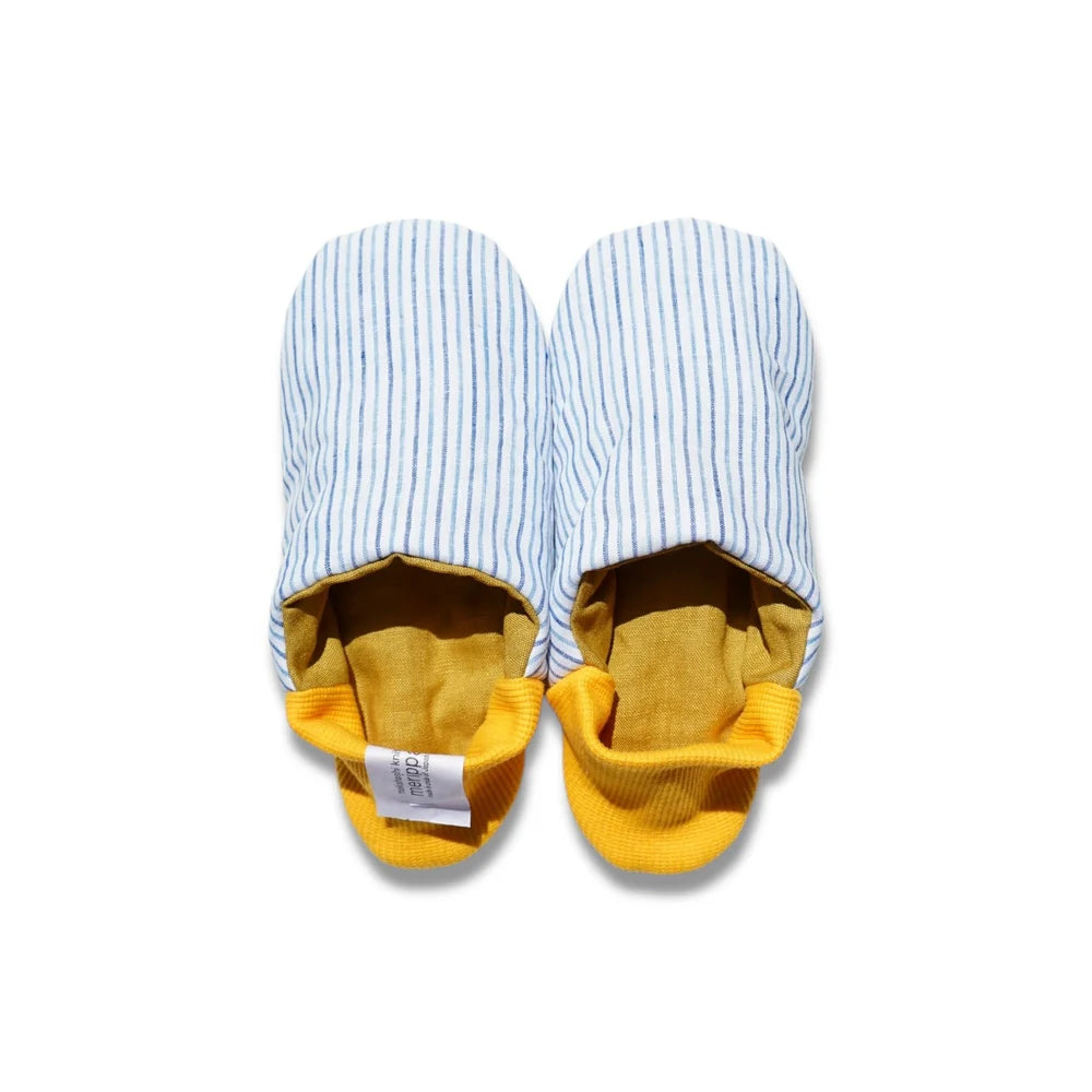 Pair of blue striped slippers with yellow heels on a white background