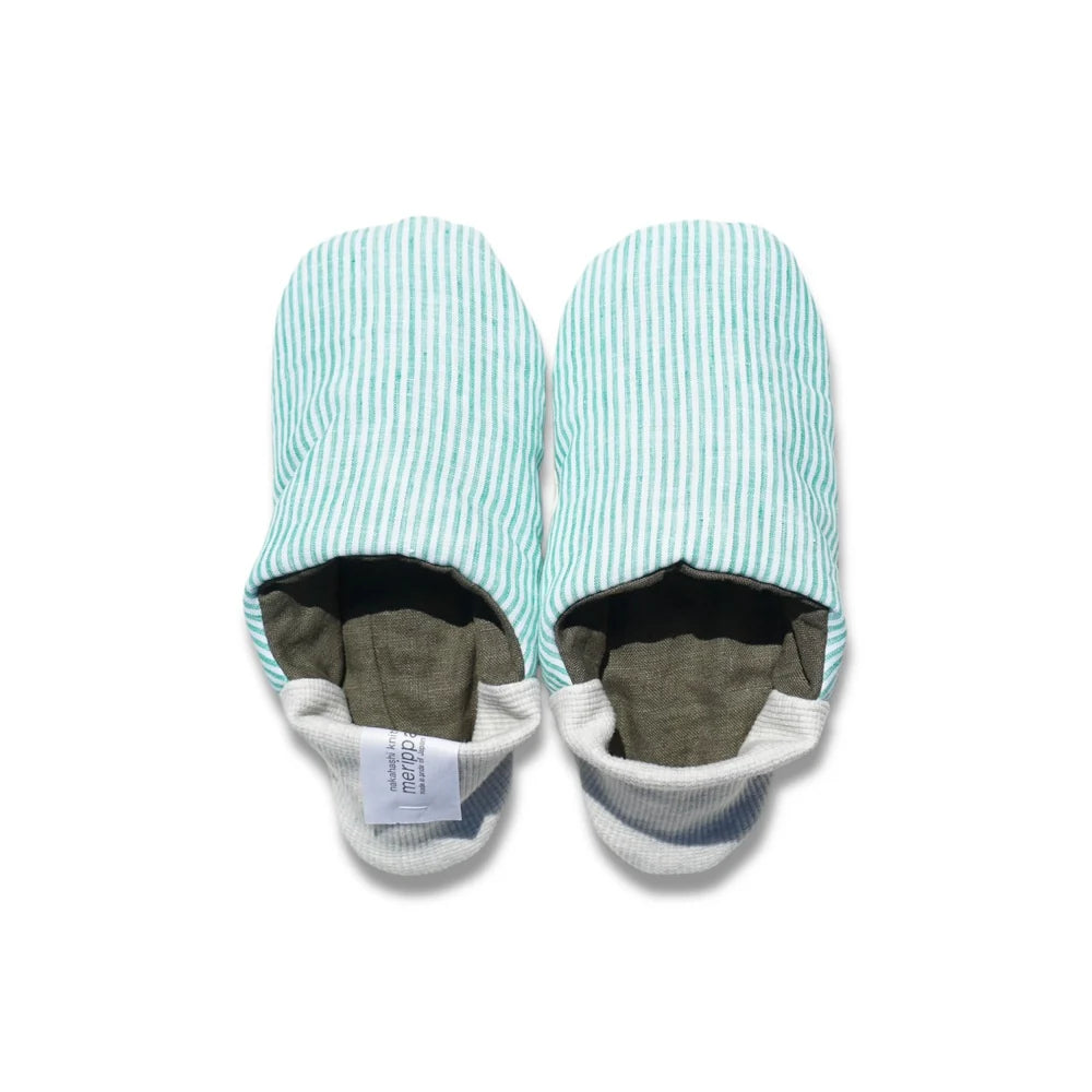 Pair of mint green and white striped slippers with light grey heels on a white background